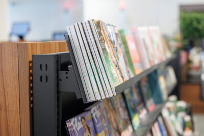 Pitch 25 shelving displaying magazines and media in Delhaize supermarket