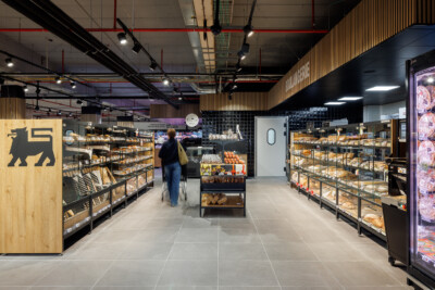 Delhaize supermarket bakery section with Gondella shelving displaying bread and pastries