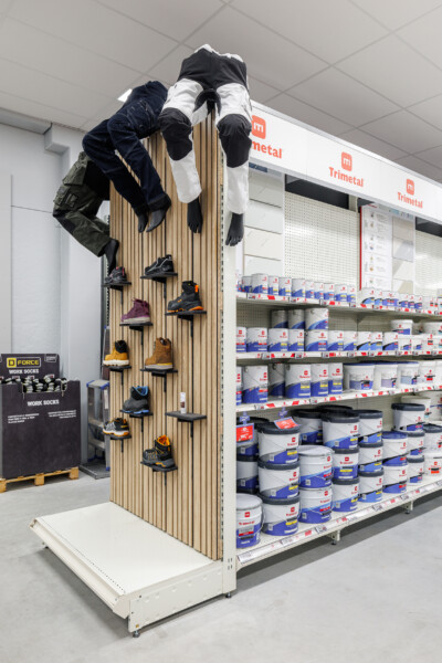 Pitch 25 shelving display with climbing mannequin wearing work clothing and boots, Trimetal branding visible