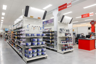 Leroy Merlin paint department with Pitch 25 shelving displaying interior and exterior paint products, checkout counter visible