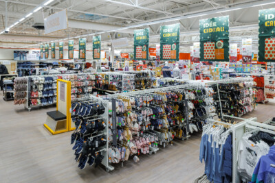 Auchan supermarket interior with Pitch shelving displaying clothing, accessories and gift items under decorative seasonal banners