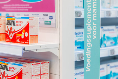 Delhaize Medi-Market pharmacy shelving displaying Defatyl Energy Plus supplement boxes and healthcare products